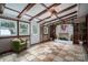 Cozy sunroom featuring wood beams, tiled floor, and a decorative fireplace at 231 Cheek Rd, Clover, SC 29710