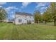 Exterior view featuring the backyard with green grass, trees, and the house at 2512 Holly Oak Ln, Gastonia, NC 28056