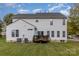 Exterior view showcasing the backyard with a deck, lush green lawn, and white siding at 2512 Holly Oak Ln, Gastonia, NC 28056