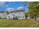 Exterior view highlighting the backyard with a deck, green lawn, and a white house at 2512 Holly Oak Ln, Gastonia, NC 28056