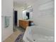 Bathroom featuring double sinks, white countertops, and a soaking tub at 2512 Holly Oak Ln, Gastonia, NC 28056