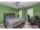 Bedroom features green walls, wood furniture, a ceiling fan, and a window with blinds at 2512 Holly Oak Ln, Gastonia, NC 28056