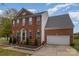 Charming brick home with a two-car garage, complemented by a manicured lawn and inviting entrance at 2512 Holly Oak Ln, Gastonia, NC 28056