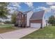 Traditional two-story brick home with a two-car garage and well-maintained landscaping at 2512 Holly Oak Ln, Gastonia, NC 28056