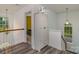 Hallway featuring gray floors, a wooden railing, and an armoire in the corner at 2512 Holly Oak Ln, Gastonia, NC 28056