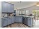 Eat-in kitchen with gray cabinets, granite counters, and view of the connected living space at 2512 Holly Oak Ln, Gastonia, NC 28056