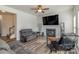 Cozy living room with a ceiling fan, fireplace, and comfortable reclining sofas at 2512 Holly Oak Ln, Gastonia, NC 28056