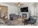 Inviting living room features a fireplace, ceiling fan, and modern flooring for a comfortable space at 2512 Holly Oak Ln, Gastonia, NC 28056