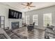 Spacious living room featuring a fireplace, ceiling fan, and a large television at 2512 Holly Oak Ln, Gastonia, NC 28056