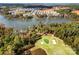 Expansive aerial view of community, golf course, and lakefront homes surrounded by lush green landscape and mature trees at 25566 Seagull Dr, Lancaster, SC 29720