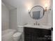 Modern bathroom featuring a gray vanity, quartz countertop, and a tiled shower at 6630 Vesuvius Furnace Rd # 1, Denver, NC 28037