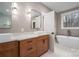 Bathroom featuring a free standing soaking tub, windows, and double sink vanity at 6630 Vesuvius Furnace Rd # 1, Denver, NC 28037