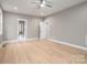 Spacious bedroom featuring a light wood floor, neutral walls, and doorways to other rooms at 6630 Vesuvius Furnace Rd # 1, Denver, NC 28037