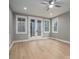 Bright bedroom features hardwood floors, a ceiling fan, and french doors to the outside at 6630 Vesuvius Furnace Rd # 1, Denver, NC 28037