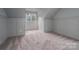 Cozy bedroom featuring wainscotting, neutral carpet, and a window for natural light at 6630 Vesuvius Furnace Rd # 1, Denver, NC 28037