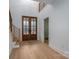 Inviting entryway with wood-framed glass doors and staircase with sleek, modern railings at 6630 Vesuvius Furnace Rd # 1, Denver, NC 28037