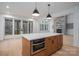 Kitchen island with built-in microwave, wood cabinets, and stone countertops at 6630 Vesuvius Furnace Rd # 1, Denver, NC 28037