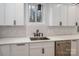 White kitchen cabinets and countertops, black hardware, and a stainless steel dishwasher at 6630 Vesuvius Furnace Rd # 1, Denver, NC 28037