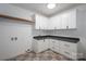 Laundry room with white cabinetry, dark countertops, and tile flooring at 6630 Vesuvius Furnace Rd # 1, Denver, NC 28037