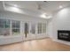 Bright living room with a fireplace, white shiplap wall and several windows with a view of the backyard at 6630 Vesuvius Furnace Rd # 1, Denver, NC 28037