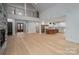 Spacious living room with high ceilings, a fireplace, hardwood floors, and an open kitchen at 6630 Vesuvius Furnace Rd # 1, Denver, NC 28037