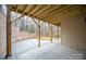 Covered patio featuring a stained wood beam ceiling and decorative brick wall at 6630 Vesuvius Furnace Rd # 1, Denver, NC 28037