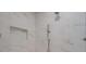 Shower stall featuring white marble style tiles, a rainfall shower head, and built in niche at 6630 Vesuvius Furnace Rd # 1, Denver, NC 28037