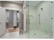 Large glass-enclosed shower with bench and marble tile provides a luxurious experience at 6630 Vesuvius Furnace Rd # 1, Denver, NC 28037