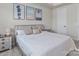 Main bedroom with light walls, a large bed, and coastal-themed art at 118 Berkeley Ave # D, Mooresville, NC 28117