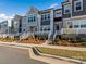 Row of townhouses showcasing a consistent design, landscaping, and white railings at 118 Berkeley Ave # D, Mooresville, NC 28117