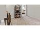 Upstairs hallway with neutral carpeting and a stylish bookshelf at 118 Berkeley Ave # D, Mooresville, NC 28117