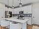 Modern kitchen with white cabinets, quartz countertops, and stainless steel appliances at 118 Berkeley Ave # D, Mooresville, NC 28117