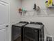 Convenient laundry room with washer, dryer, and overhead shelving at 118 Berkeley Ave # D, Mooresville, NC 28117