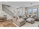 Living room with L-shaped sectional sofa and hardwood floors at 118 Berkeley Ave # D, Mooresville, NC 28117