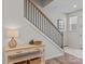 Modern staircase with a metal railing and a light wood console table at 118 Berkeley Ave # D, Mooresville, NC 28117