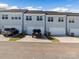 Rear view of three townhouses with attached garages and parking at 118 Berkeley Ave # D, Mooresville, NC 28117