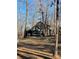 Secluded dark wood cabin with deck and surrounding trees at 1386 Old Pinckney Rd, York, SC 29745