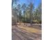 Wooded lot with rock and distant road at 1386 Old Pinckney Rd, York, SC 29745