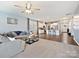 Open living space with gray sectional sofa, hardwood floors, and kitchen views at 1008 Hills Oak Ln, Charlotte, NC 28269