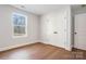 Simple bedroom features hardwood floors, closet space, and a well-lit window at 119 E Ohio Ave, Bessemer City, NC 28016