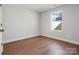 Cozy bedroom with hardwood floors and a window that provides natural light at 119 E Ohio Ave, Bessemer City, NC 28016