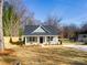 Charming home featuring a well-maintained front yard, mature trees, and classic architectural details at 119 E Ohio Ave, Bessemer City, NC 28016