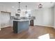 Modern kitchen boasts white cabinetry, stainless steel appliances, and a stylish center island at 119 E Ohio Ave, Bessemer City, NC 28016