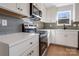 Close-up of a modern kitchen featuring stainless steel appliances, sleek countertops, and stylish backsplash at 119 E Ohio Ave, Bessemer City, NC 28016