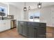 Kitchen with stylish island, stainless steel dishwasher, and ample white cabinetry at 119 E Ohio Ave, Bessemer City, NC 28016