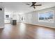 Bright living room featuring hardwood floors, a ceiling fan, and an open floor plan to the kitchen at 119 E Ohio Ave, Bessemer City, NC 28016
