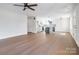 Spacious living room with hardwood floors, ceiling fan, and seamless flow into the modern kitchen at 119 E Ohio Ave, Bessemer City, NC 28016