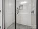 Modern shower featuring sleek black hardware, white subway tile, and a gray shower pan at 119 E Ohio Ave, Bessemer City, NC 28016