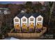 Rear view of three townhouses with private decks and fenced yards at 158 Mattoon St, Charlotte, NC 28216