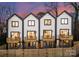 Rear view of three townhouses with private decks and fenced yards at 158 Mattoon St, Charlotte, NC 28216